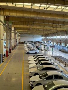 Warehouse inventory of 2019 white Geely Geometry A electric cars, ready for bulk export to Nigeria, Algeria, and Ethiopia.