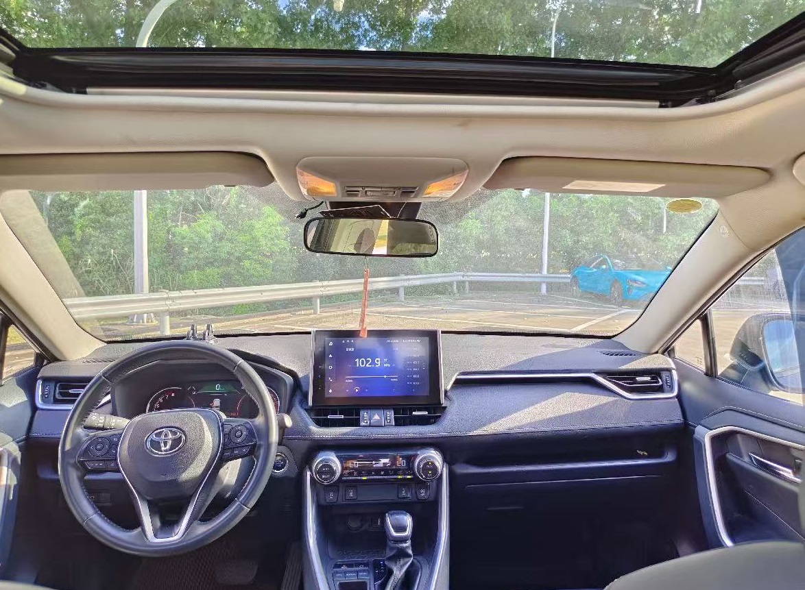 Modern dashboard with touchscreen display in the 2023 Toyota RAV4, featuring automatic climate control.