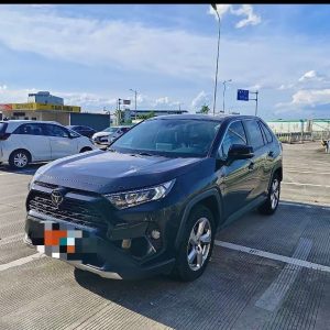 White 2023 Toyota RAV4 front grille and headlight, a reliable SUV ready for export to Africa.