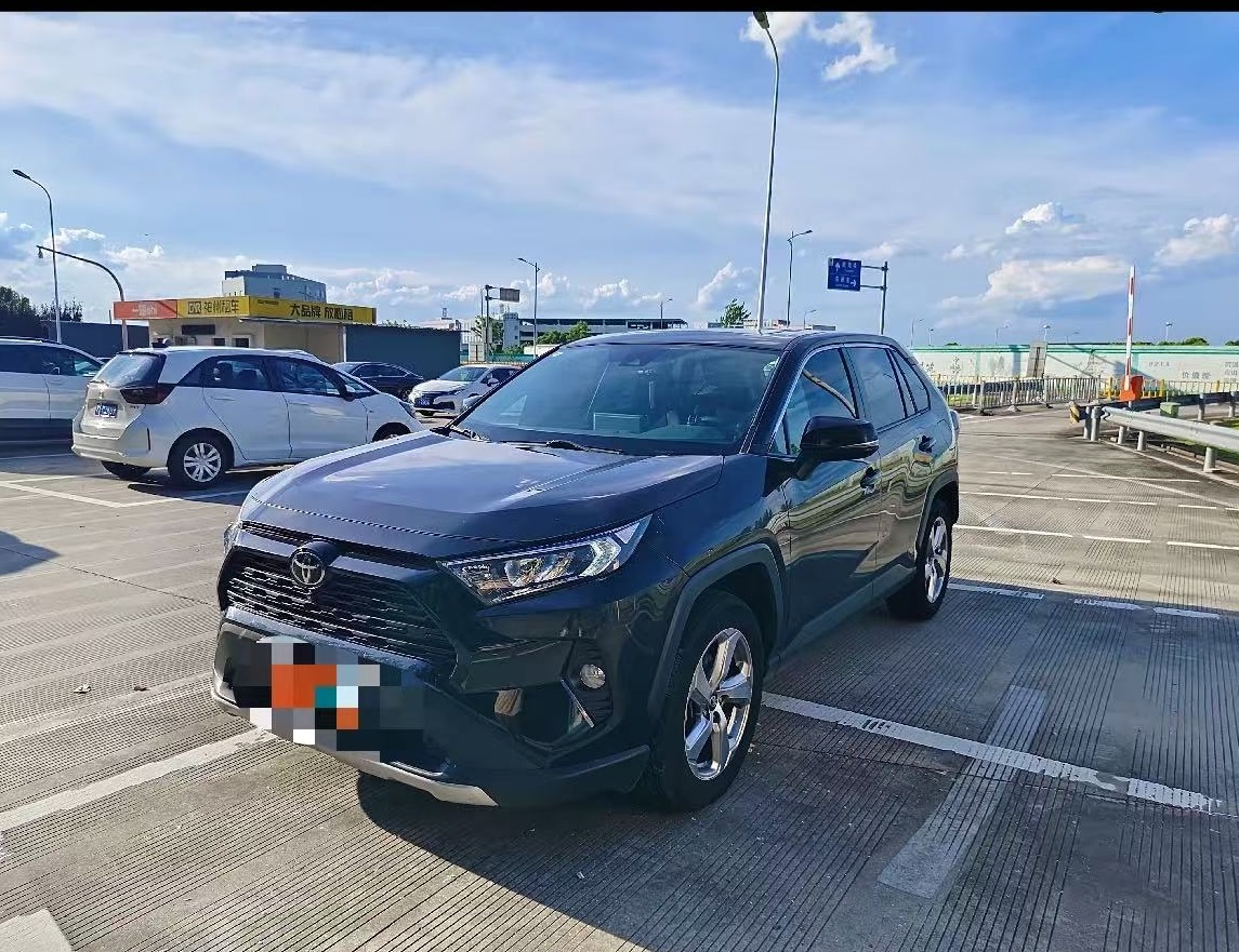 White 2023 Toyota RAV4 front grille and headlight, a reliable SUV ready for export to Africa.