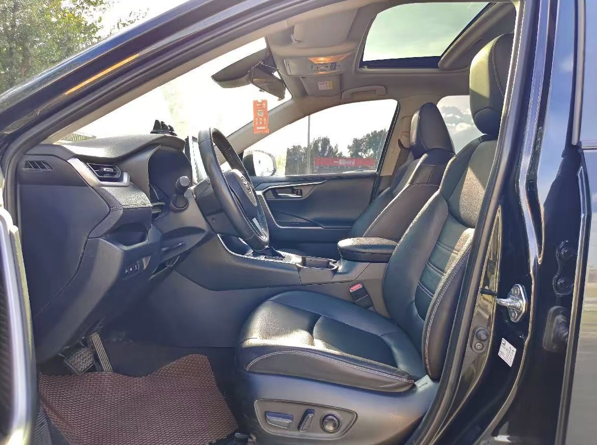 Comfortable and adjustable leather front seats in the 2023 Toyota RAV4, perfect for long drives.